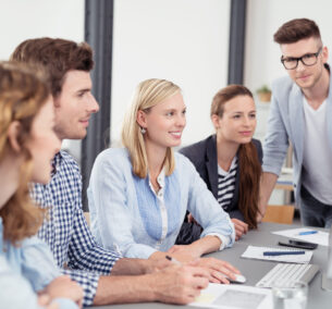 Five,Young,Office,Workers,Reading,Something,On,Computer,Together,While Five,Young,Office,Workers,Reading,Something,On,Computer,Together,While